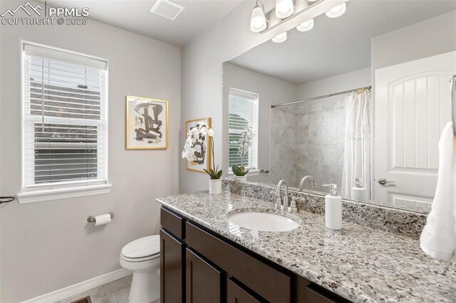 bathroom with tile patterned floors, vanity, a shower with shower curtain, and toilet