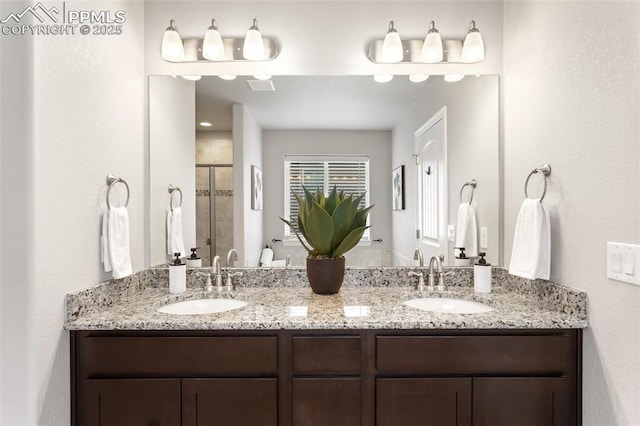 bathroom with a shower with door and vanity