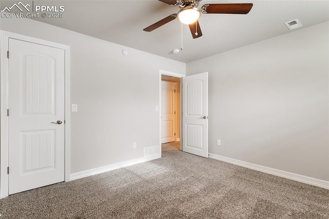 unfurnished room featuring ceiling fan and carpet floors