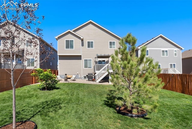 rear view of property featuring a patio area and a yard