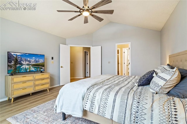 bedroom with ceiling fan, wood-type flooring, and vaulted ceiling