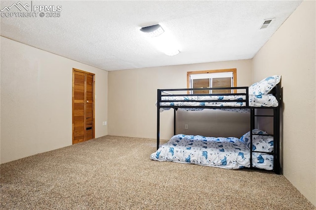 bedroom with carpet and a textured ceiling