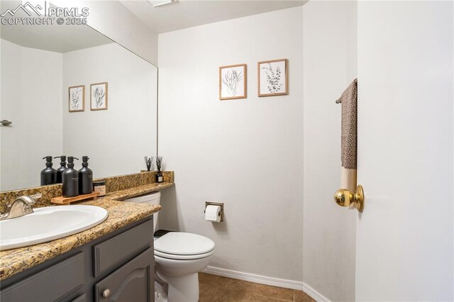 bathroom with tile patterned floors, vanity, and toilet