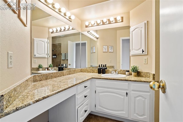 bathroom featuring vanity and a shower