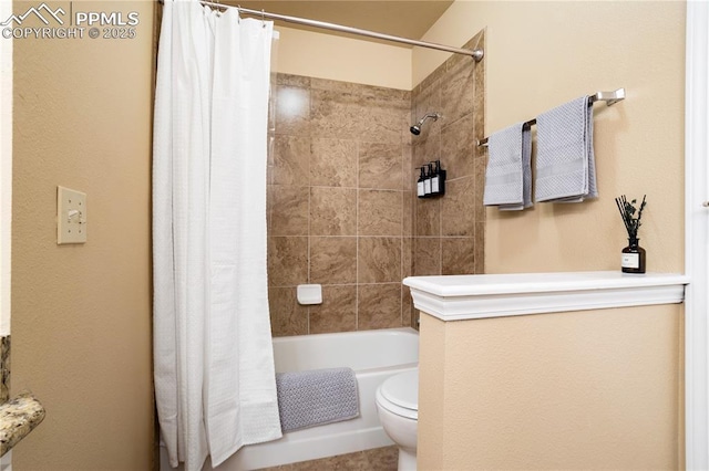 bathroom featuring shower / bathtub combination with curtain and toilet