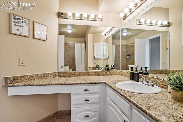 bathroom featuring a shower with shower curtain, vanity, and tile patterned floors