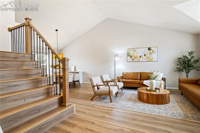 living room featuring lofted ceiling and light wood-type flooring