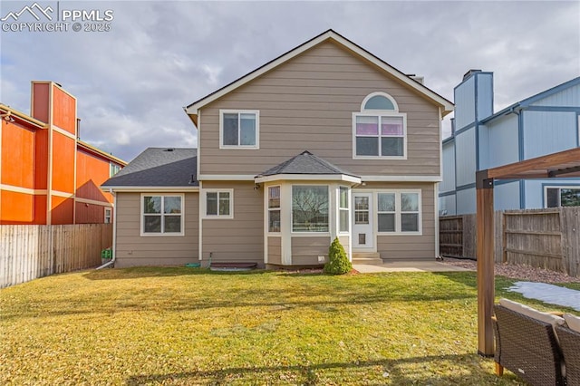 rear view of property featuring a yard and a patio