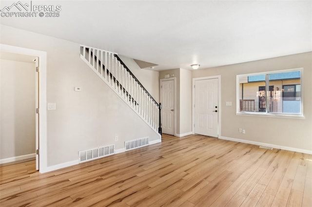 foyer entrance with light hardwood / wood-style flooring