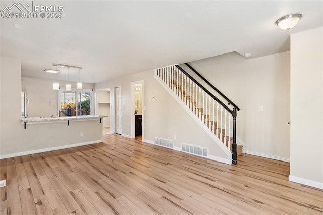 unfurnished living room featuring light wood-type flooring