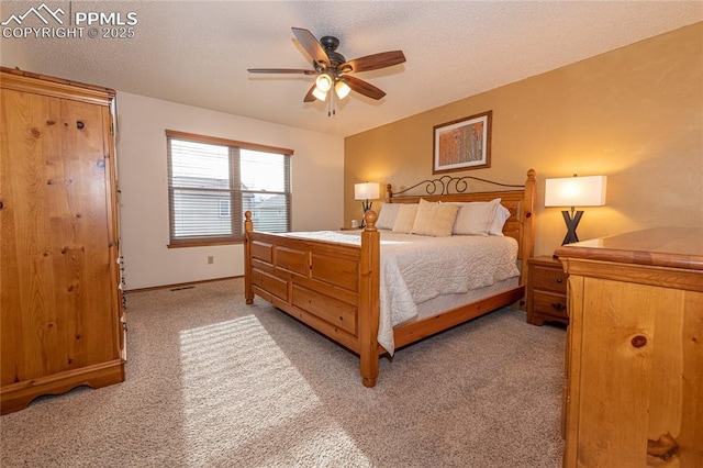 bedroom with ceiling fan and light carpet