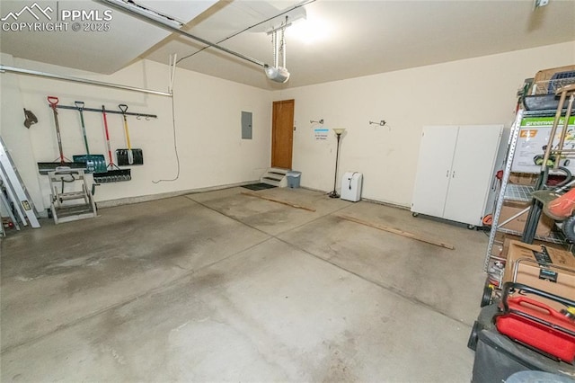 garage featuring electric panel and a garage door opener