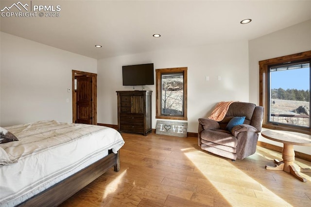 bedroom featuring baseboards, light wood-style flooring, and recessed lighting