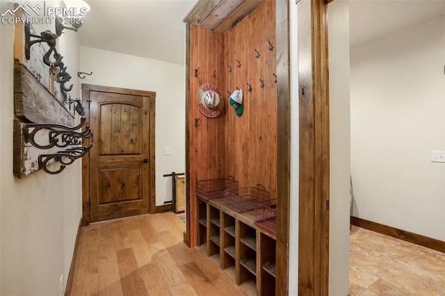 mudroom with baseboards and light wood-style floors