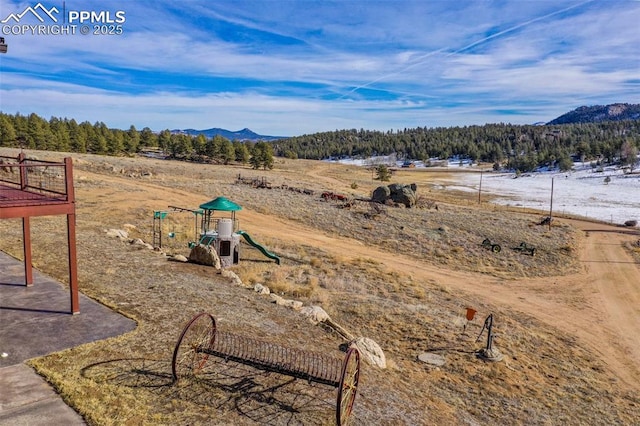 view of yard with a mountain view and a playground