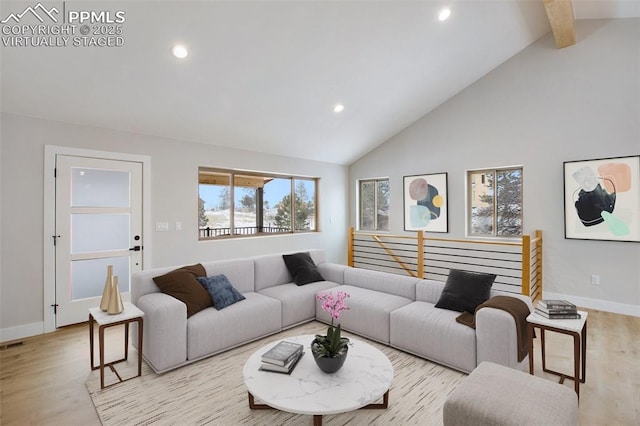 living room with beam ceiling, high vaulted ceiling, and light hardwood / wood-style flooring