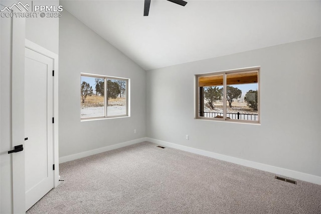 unfurnished room with ceiling fan, light colored carpet, and vaulted ceiling