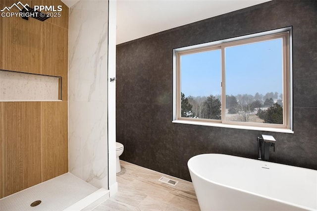 bathroom featuring toilet, shower with separate bathtub, and tile walls