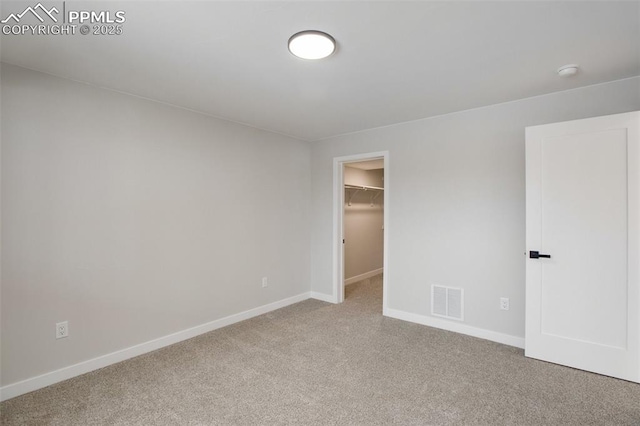 spare room featuring light colored carpet