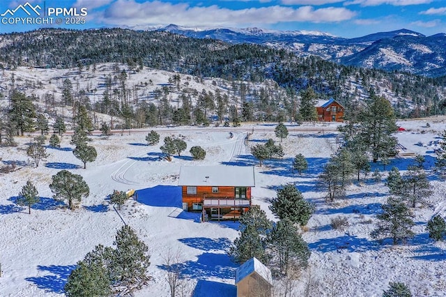 snowy aerial view with a mountain view