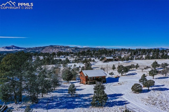 snowy aerial view featuring a mountain view