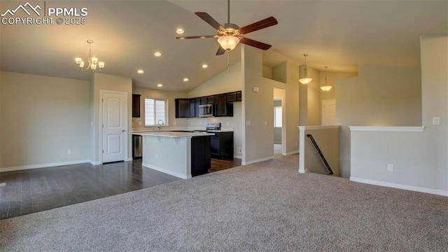 kitchen with pendant lighting, a center island, dark brown cabinets, ceiling fan with notable chandelier, and dark colored carpet