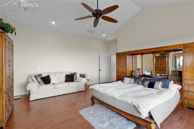 bedroom featuring ceiling fan, dark wood-type flooring, and high vaulted ceiling