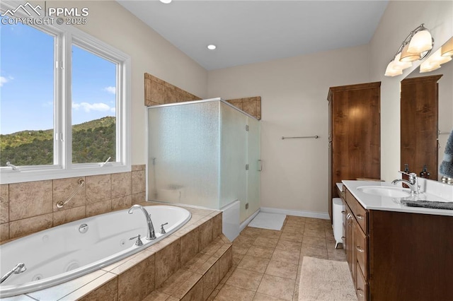 bathroom with plus walk in shower, vanity, tile patterned floors, and plenty of natural light