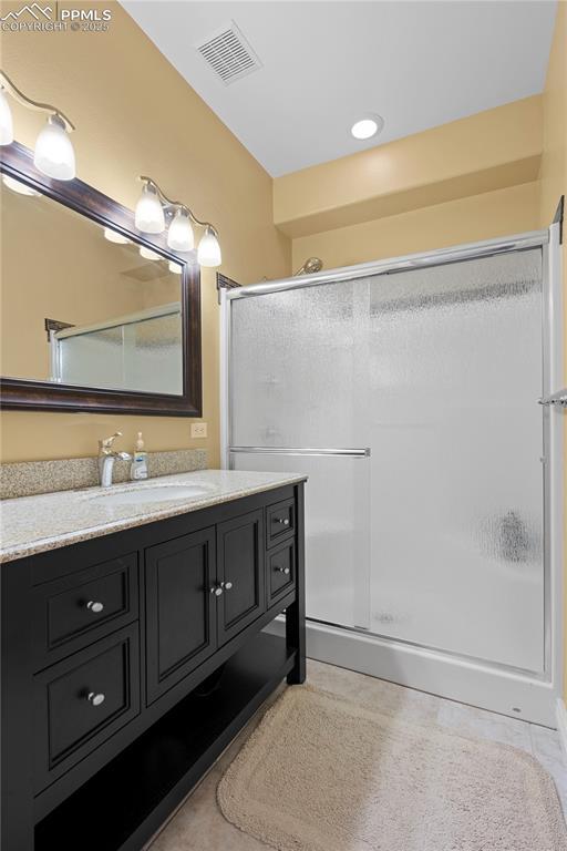 bathroom with vanity and an enclosed shower