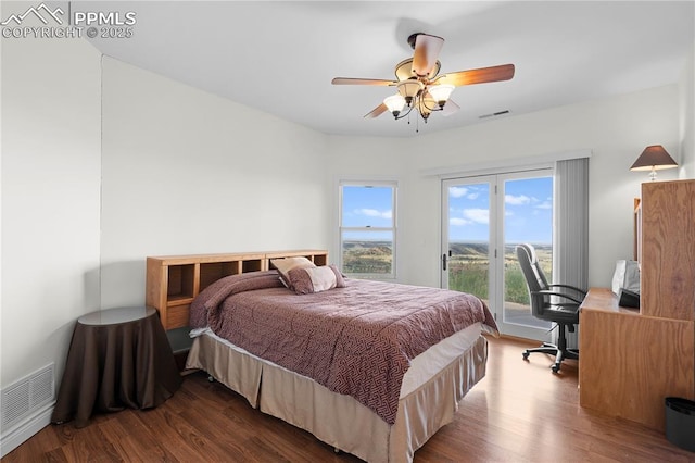 bedroom featuring hardwood / wood-style flooring, ceiling fan, and access to outside