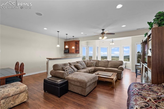 living room with dark hardwood / wood-style flooring and ceiling fan