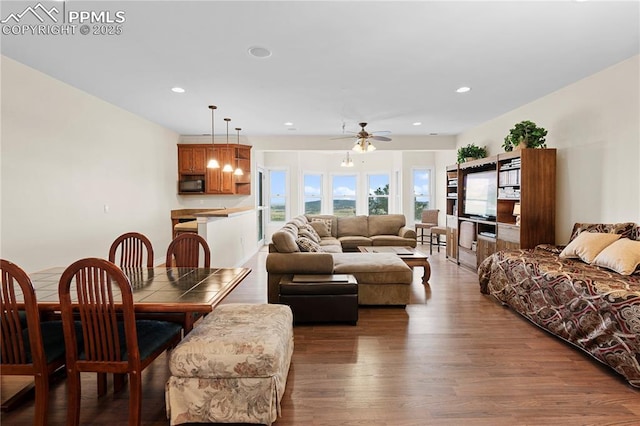 living room featuring wood-type flooring and ceiling fan