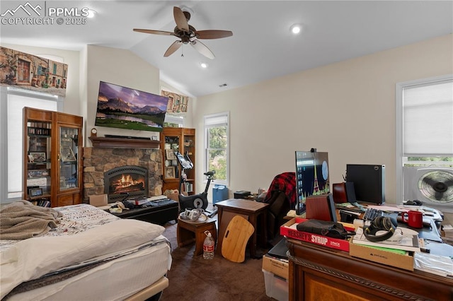 bedroom featuring dark colored carpet, ceiling fan, a fireplace, and vaulted ceiling