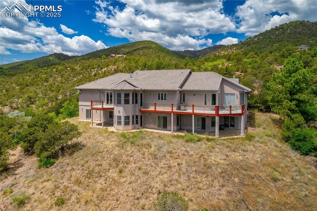 rear view of property with a mountain view