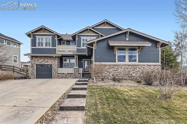 craftsman inspired home featuring a garage, a balcony, and a front yard