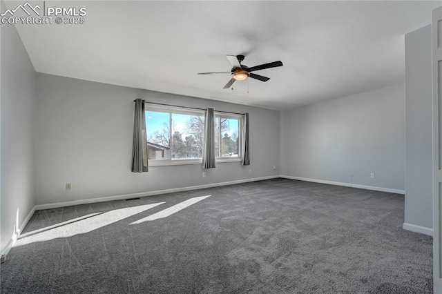 empty room featuring ceiling fan and dark carpet