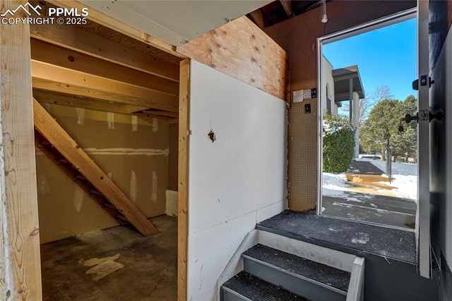 staircase featuring concrete floors