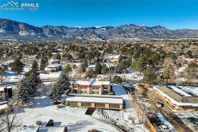 snowy aerial view with a mountain view