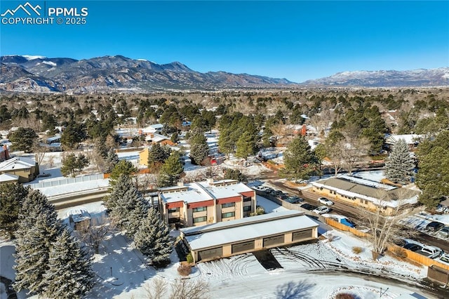 snowy aerial view with a mountain view