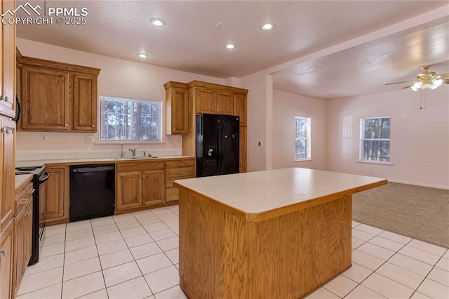 13264 Teller County Rd, Florissant, CO 80816 - kitchen featuring black appliances, light colored carpet, ceiling fan, a kitchen island, and sink