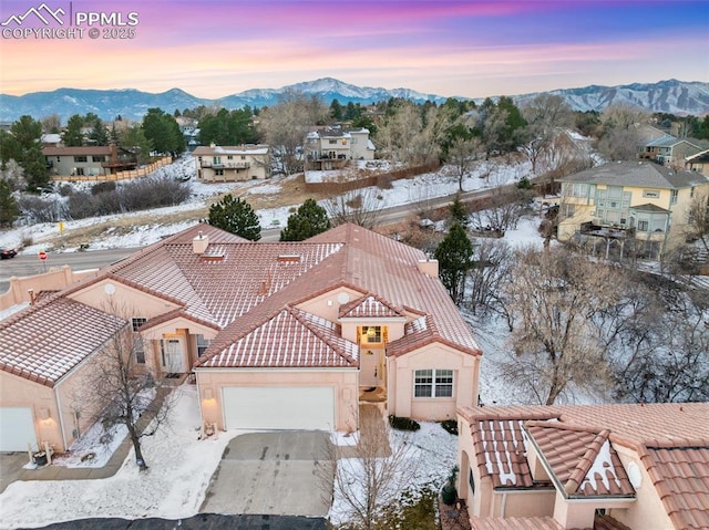 snowy aerial view with a mountain view