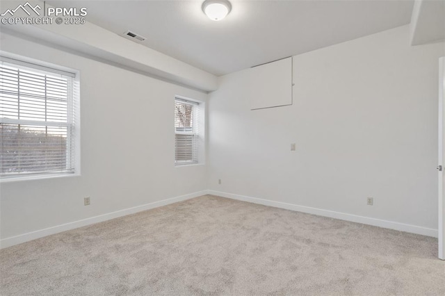 unfurnished room featuring light colored carpet