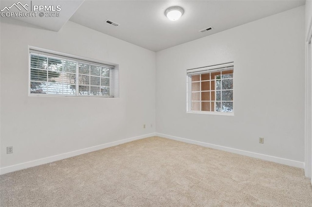 empty room featuring light carpet