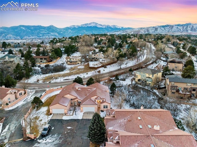 snowy aerial view featuring a mountain view