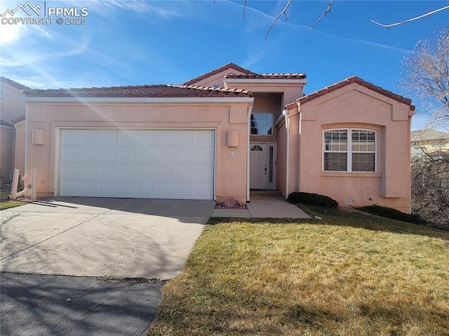 view of front of house featuring a front yard and a garage