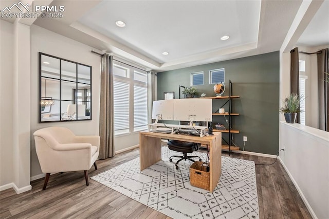 office featuring hardwood / wood-style floors and a raised ceiling