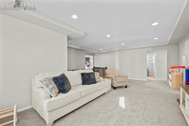 living room with carpet and a tray ceiling