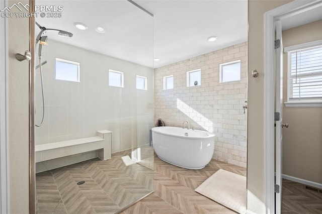 bathroom featuring tile walls, parquet floors, and independent shower and bath