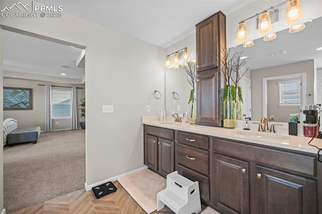 bathroom with a healthy amount of sunlight and vanity