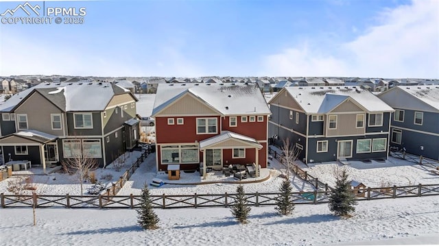 view of snow covered rear of property